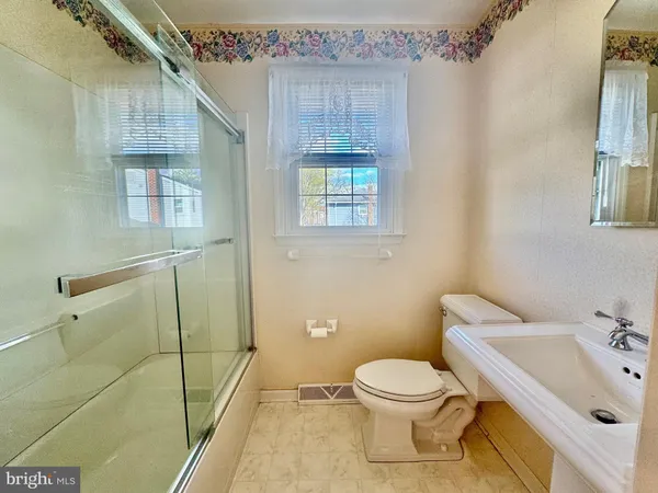 a bathroom with a granite countertop sink mirror and double