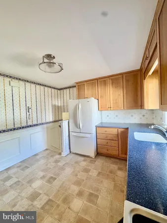 a view of a kitchen with a sink and cabinets