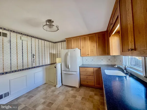 a kitchen with a refrigerator and a sink
