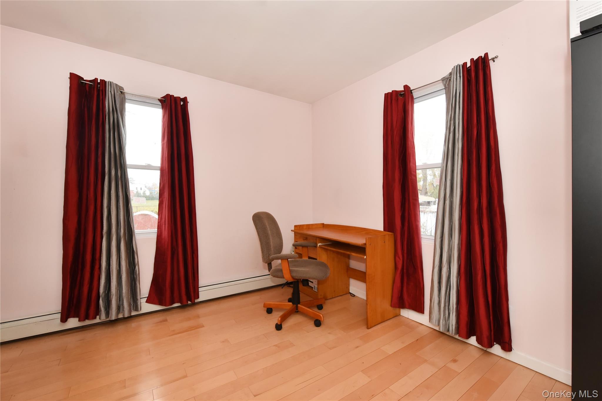 113 Stewart Avenue Hempstead, NY 11550 - Photo 18 of 30 a room with a window and a chair