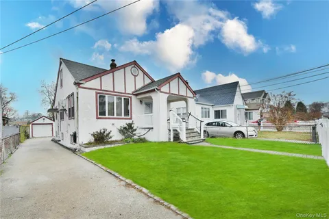 a front view of house with yard and green space