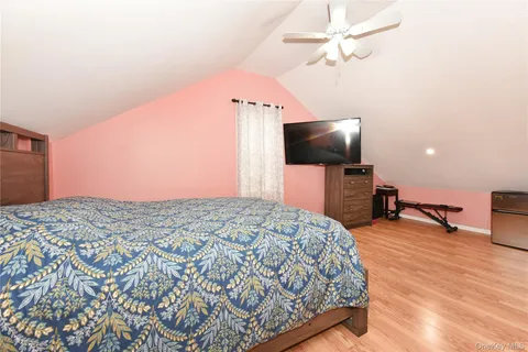 a bedroom with a bed and a television