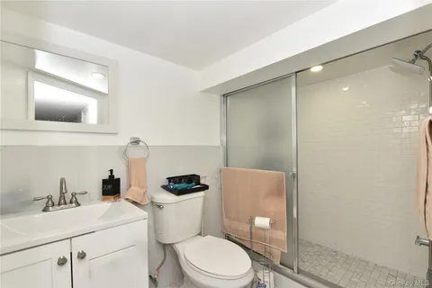 a bathroom with a toilet a sink and shower