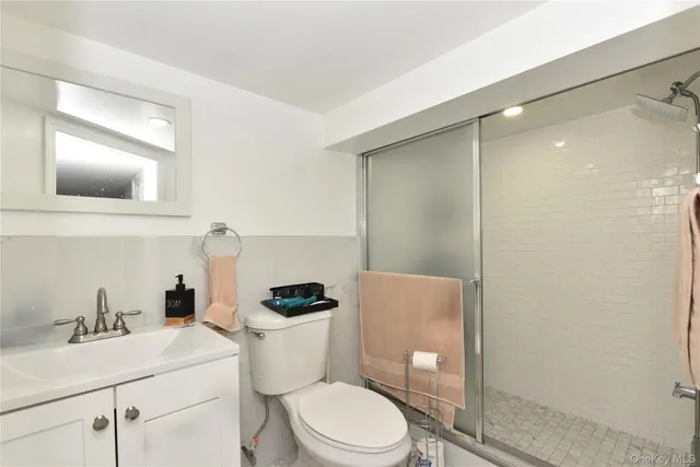 a bathroom with a toilet a sink and shower