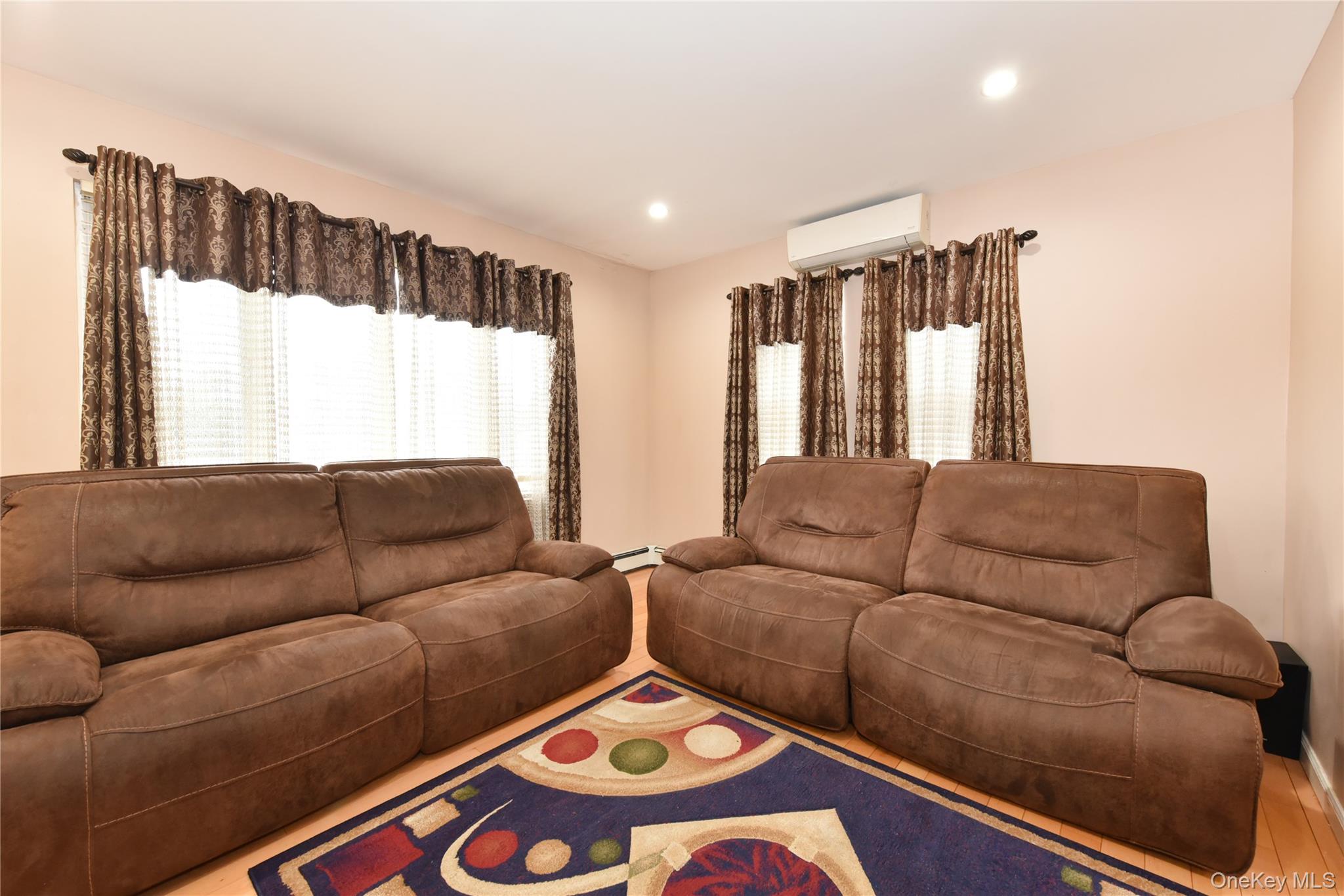 113 Stewart Avenue Hempstead, NY 11550 - Photo 10 of 30 a living room with furniture and a large window