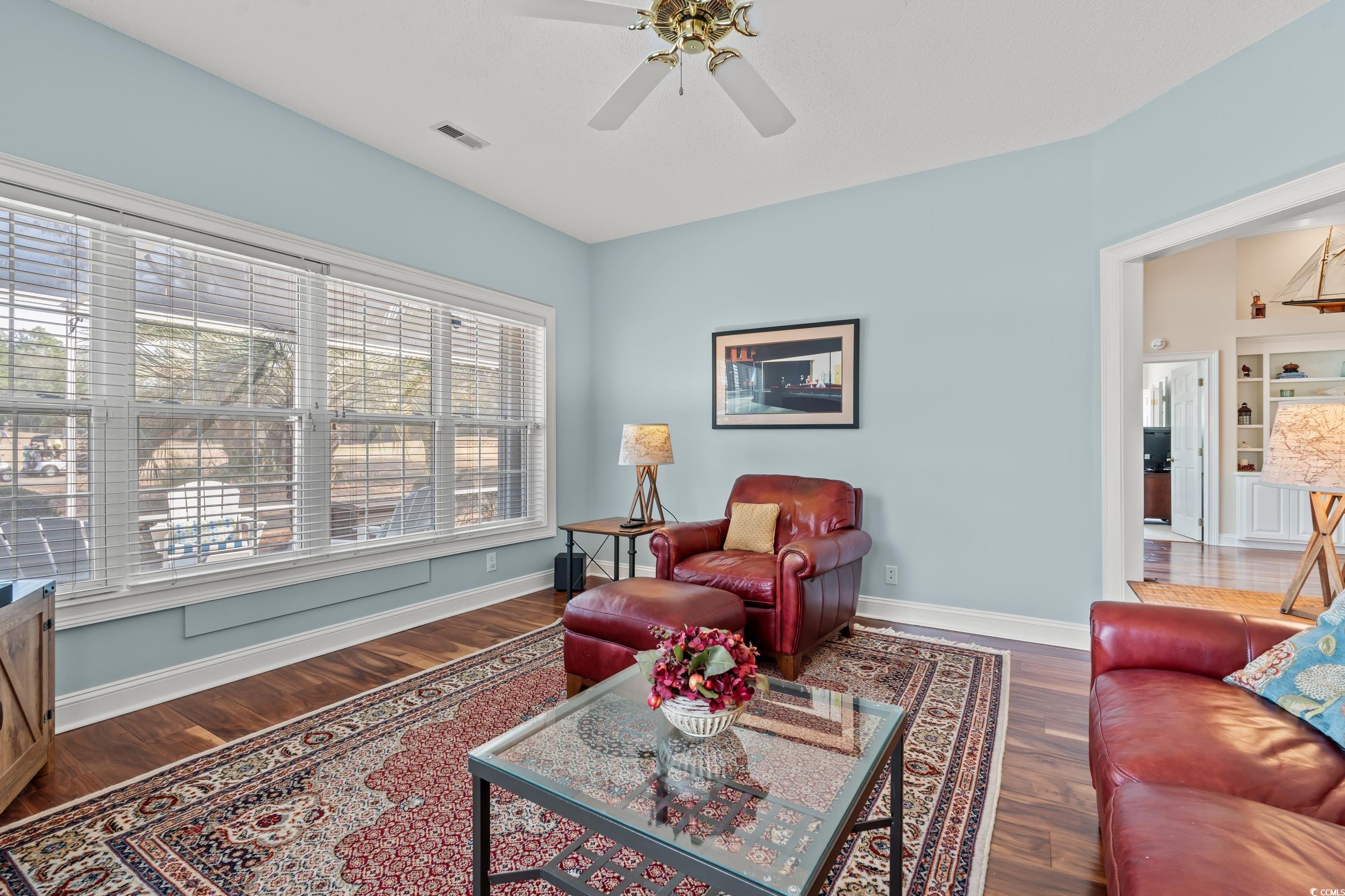 30 Baldwin Loop Pawleys Island, SC 29585 - Photo 14 of 39 Living room featuring a ceiling fan, wood finished