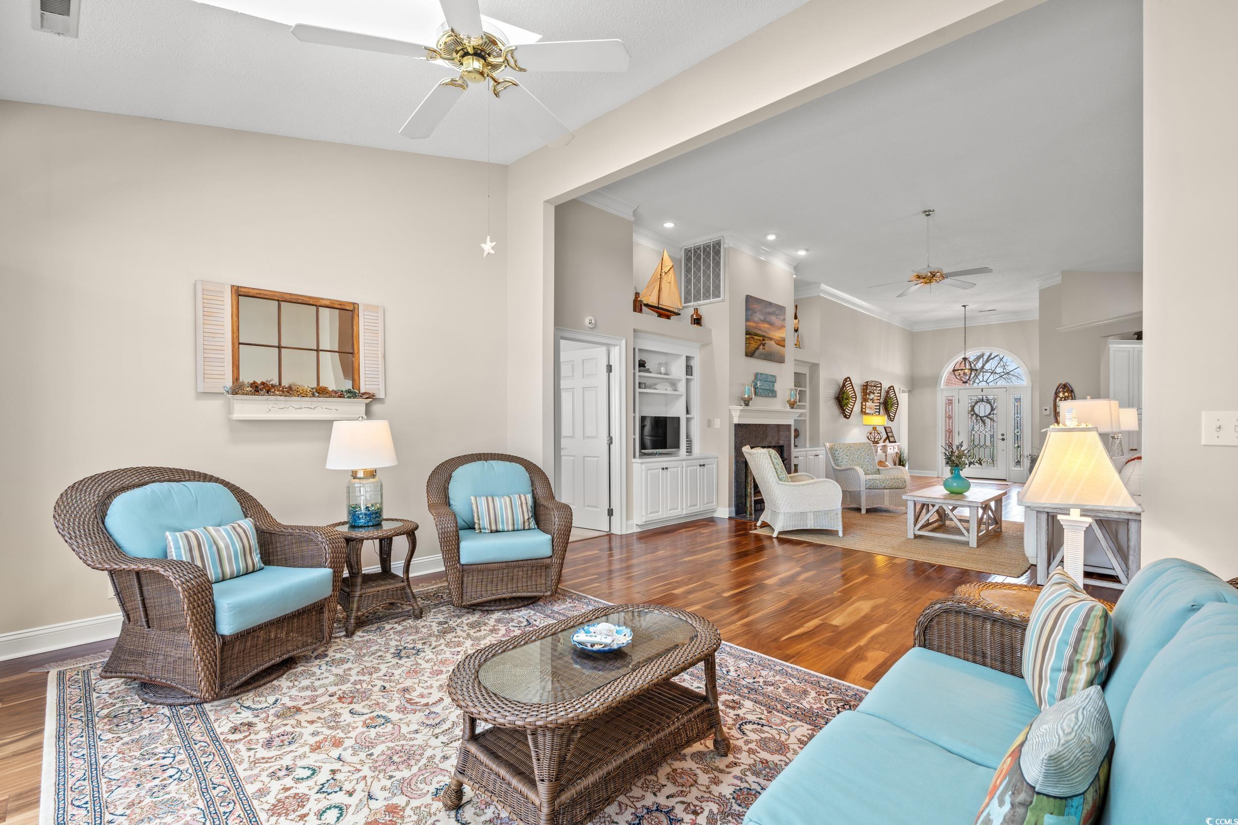30 Baldwin Loop Pawleys Island, SC 29585 - Photo 17 of 39 Living room with ceiling fan, a fireplace, wood fi