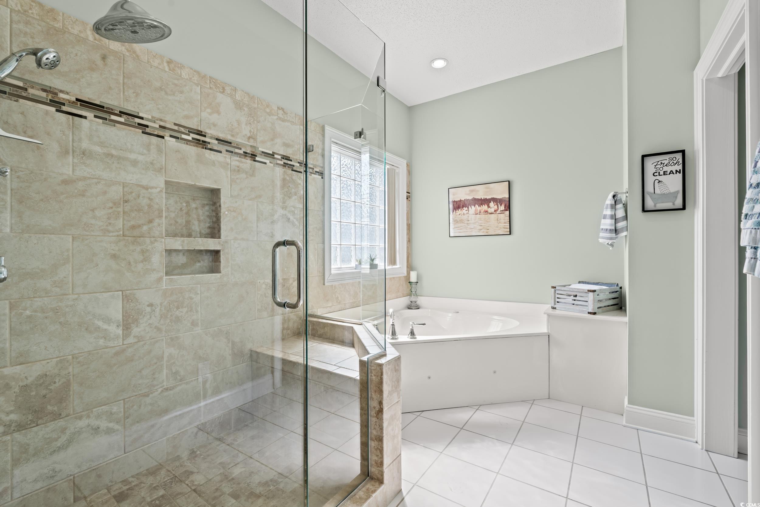 30 Baldwin Loop Pawleys Island, SC 29585 - Photo 26 of 39 Bathroom with a garden tub, tile patterned floorin