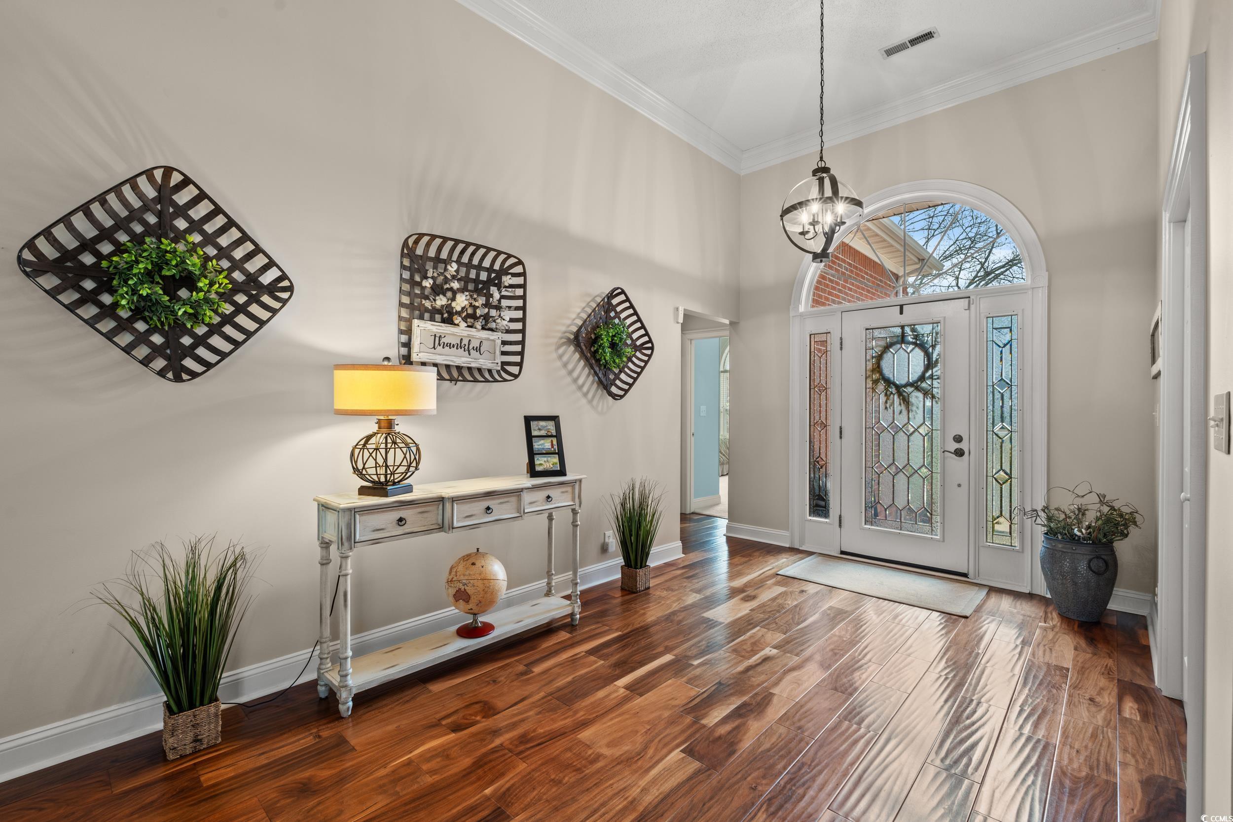 30 Baldwin Loop Pawleys Island, SC 29585 - Photo 3 of 39 Foyer entrance with dark wood-style floors, a towe