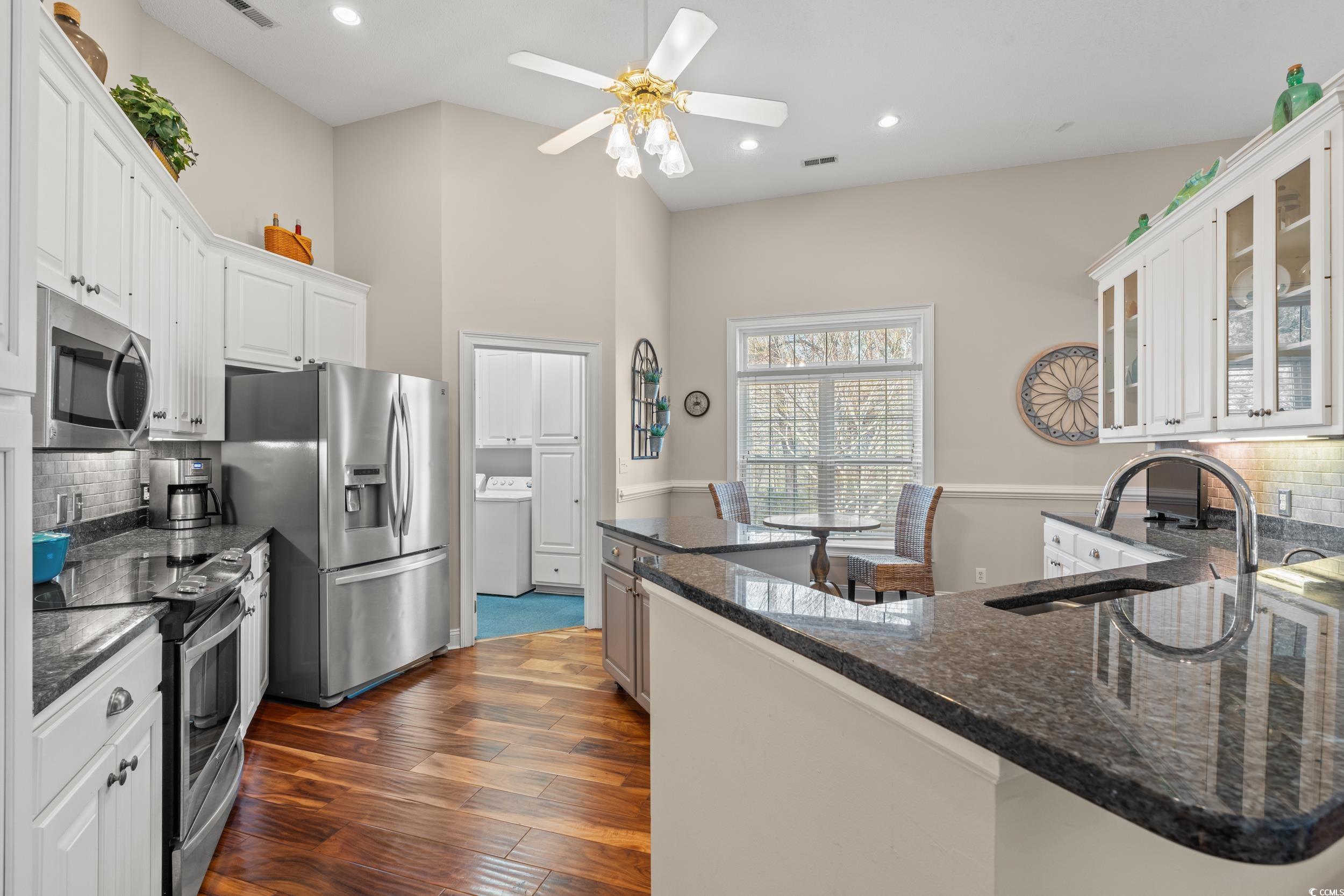 30 Baldwin Loop Pawleys Island, SC 29585 - Photo 8 of 39 Kitchen with dark wood-style floors, stainless ste