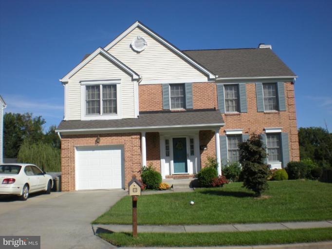 9517 Stoneoak Road Nottingham, MD 21236 - Photo 2 of 3 a front view of a house with a yard and garage