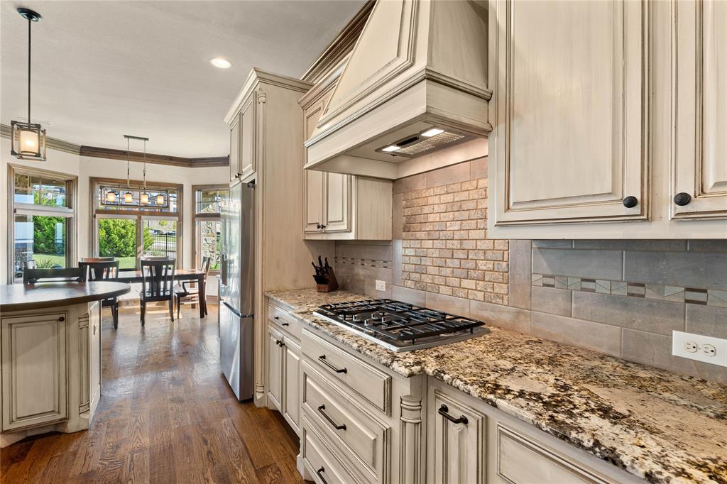 293 Harborview Drive Rockwall, TX 75032 - Photo 11 of 37 a kitchen with a stove a sink and cabinets