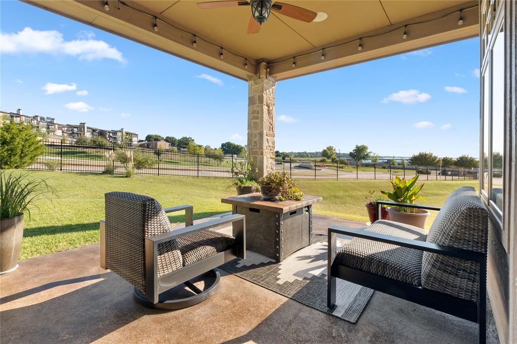 293 Harborview Drive Rockwall, TX 75032 - Photo 34 of 37 a roof deck with outdoor seating and water view