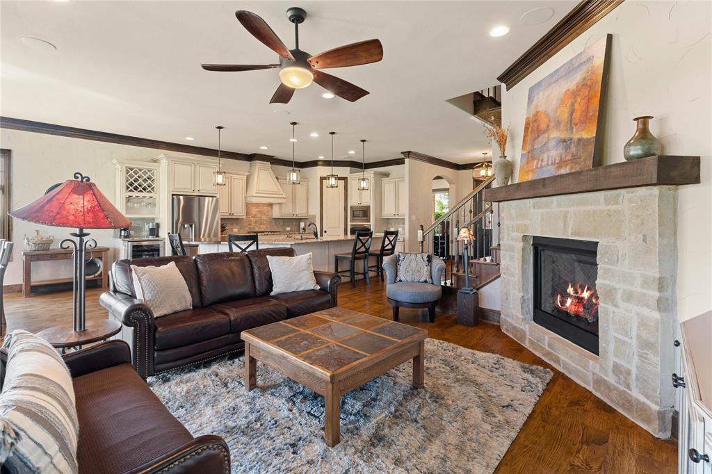 293 Harborview Drive Rockwall, TX 75032 - Photo 5 of 37 a living room with furniture a fireplace and a table