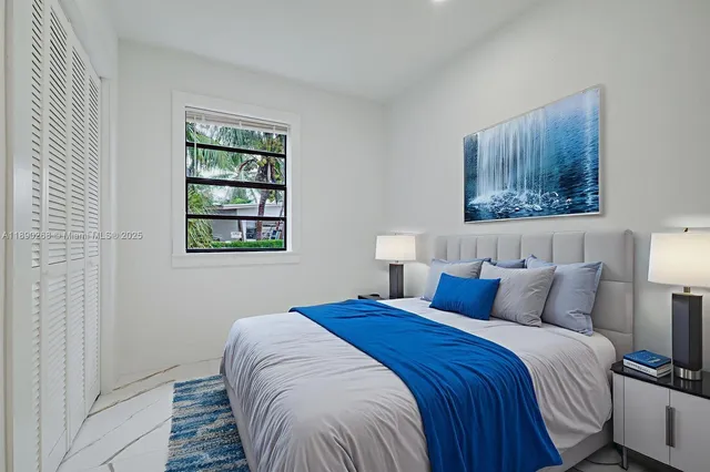 a bedroom with a bed and a night stand