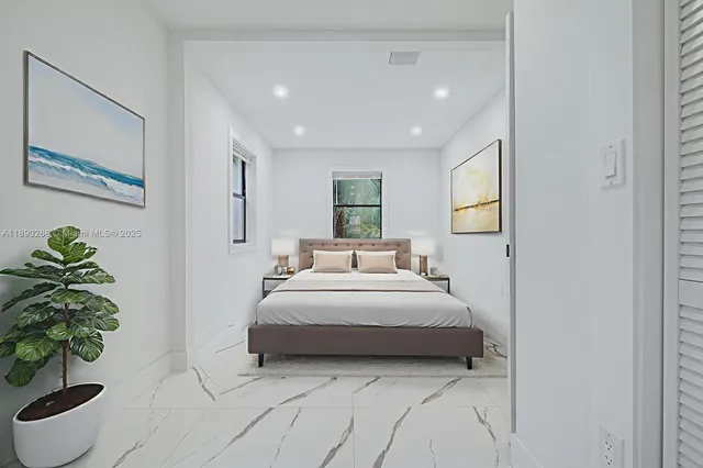 a spacious bedroom with a bed and a potted plant
