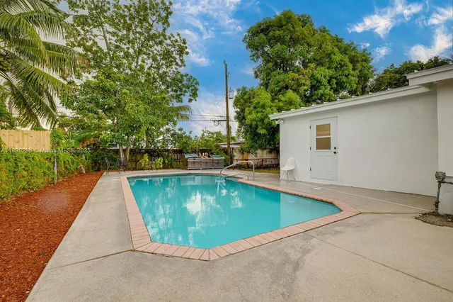 a view of a swimming pool with a yard