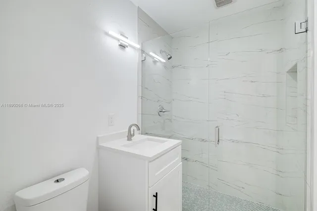 a bathroom with a toilet sink and shower