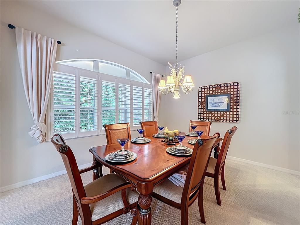 17 Sweetbay Court Homosassa, FL 34446 - Photo 11 of 61 a dining room with furniture a chandelier and a rug