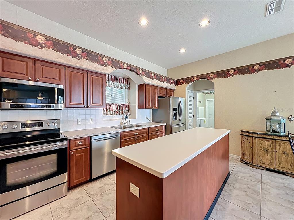 17 Sweetbay Court Homosassa, FL 34446 - Photo 17 of 61 a kitchen with stainless steel appliances a sink and a stove top oven