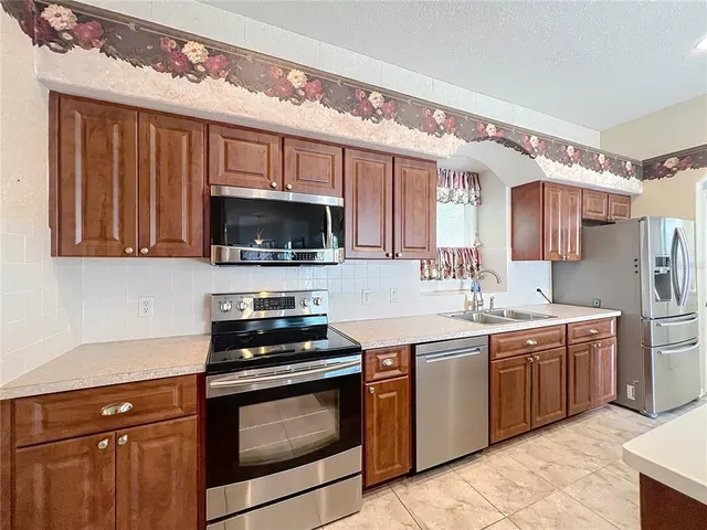 a kitchen with stainless steel appliances a stove microwave and cabinets