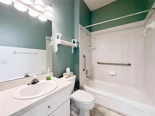 en empty room with closet and a chandelier fan