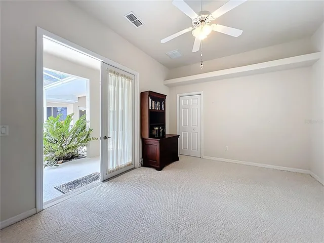a view of a backyard with plants and a patio