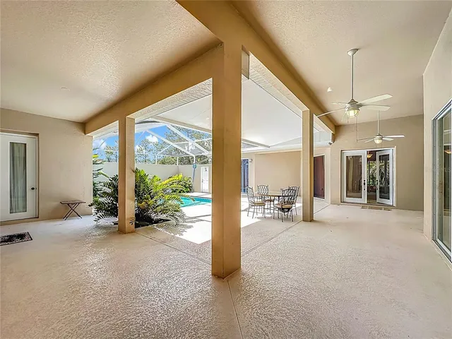 a view of a big room with balcony furniture and floor to ceiling window