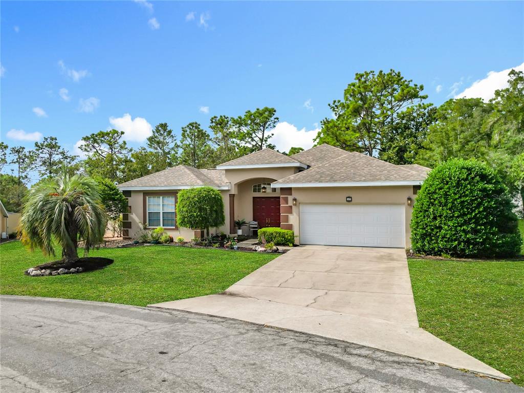 17 Sweetbay Court Homosassa, FL 34446 - Photo 61 of 61 a front view of a house with a garden and yard