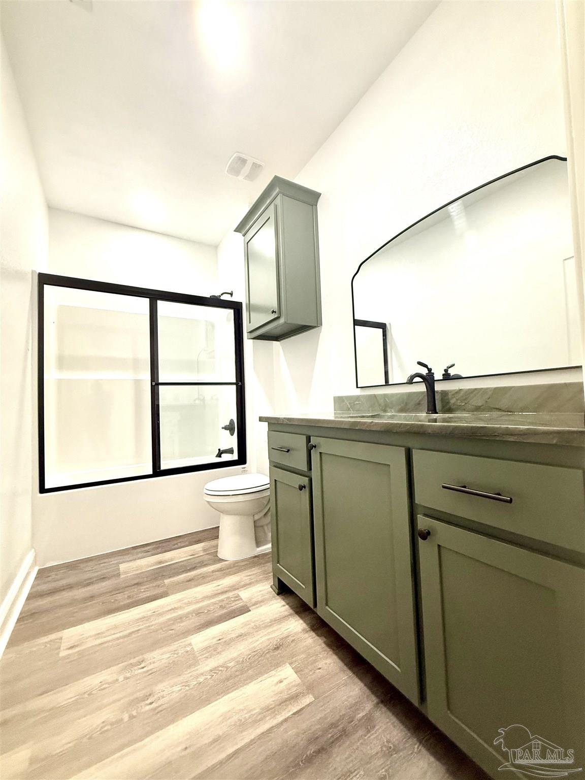 4035 Charles Circle Pace, FL 32571 - Photo 24 of 68 a bathroom with a sink and a large mirror