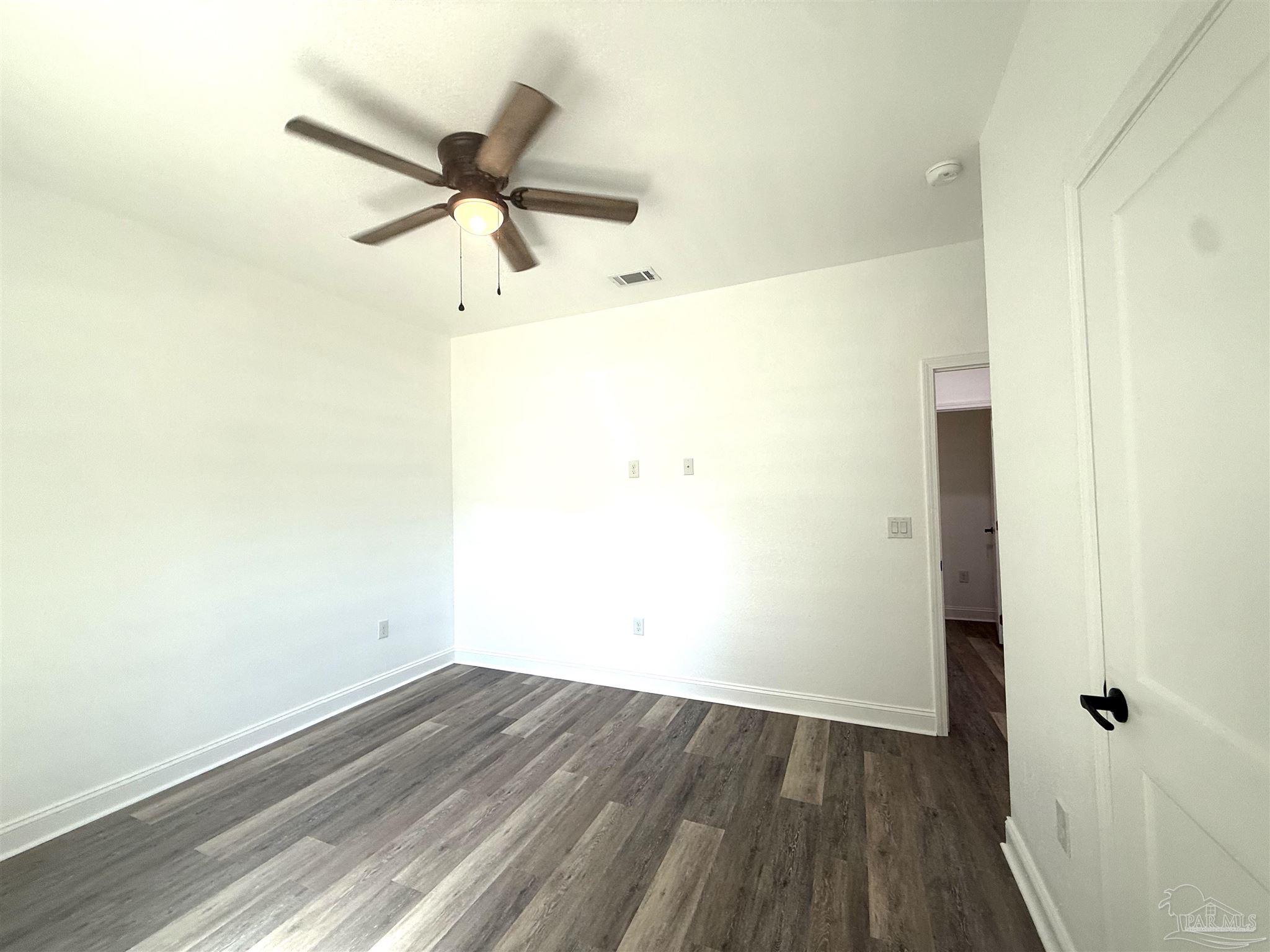 4035 Charles Circle Pace, FL 32571 - Photo 26 of 68 an empty room with wooden floor and windows