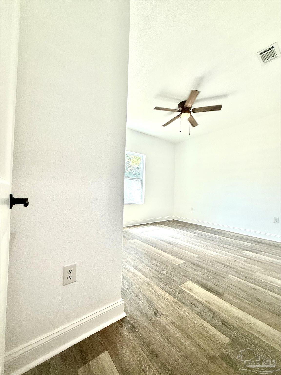 4035 Charles Circle Pace, FL 32571 - Photo 27 of 68 a view of a room with wooden floor