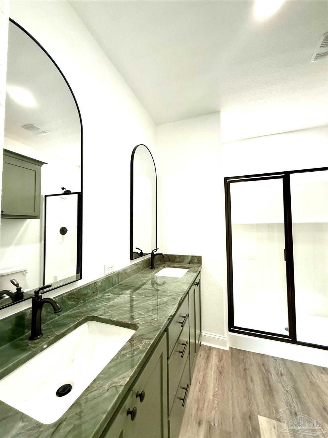 4035 Charles Circle Pace, FL 32571 - Photo 41 of 68 a bathroom with a granite countertop sink and a mirror