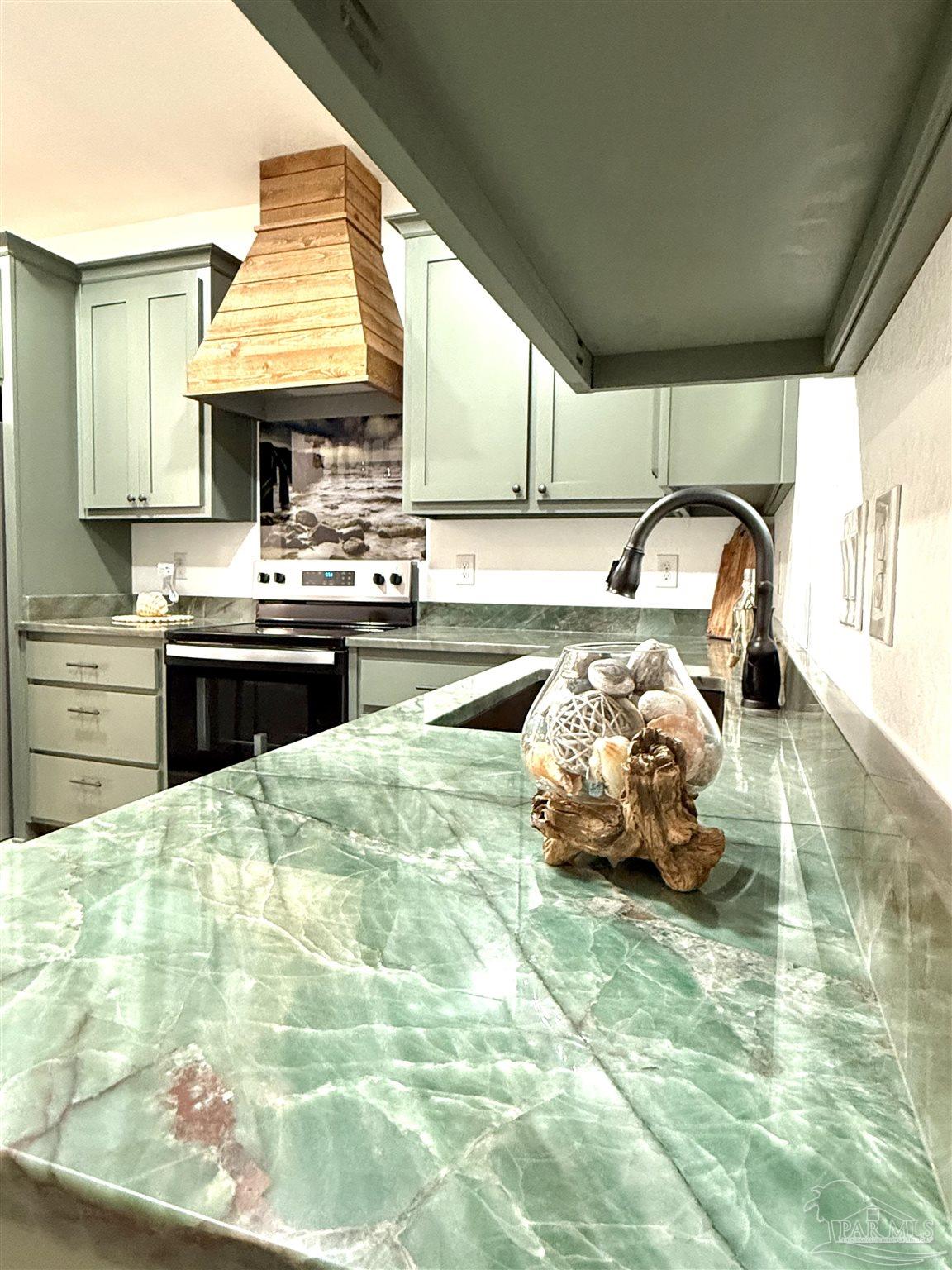 4035 Charles Circle Pace, FL 32571 - Photo 56 of 68 a kitchen with kitchen island granite countertop a stove a sink and a microwave