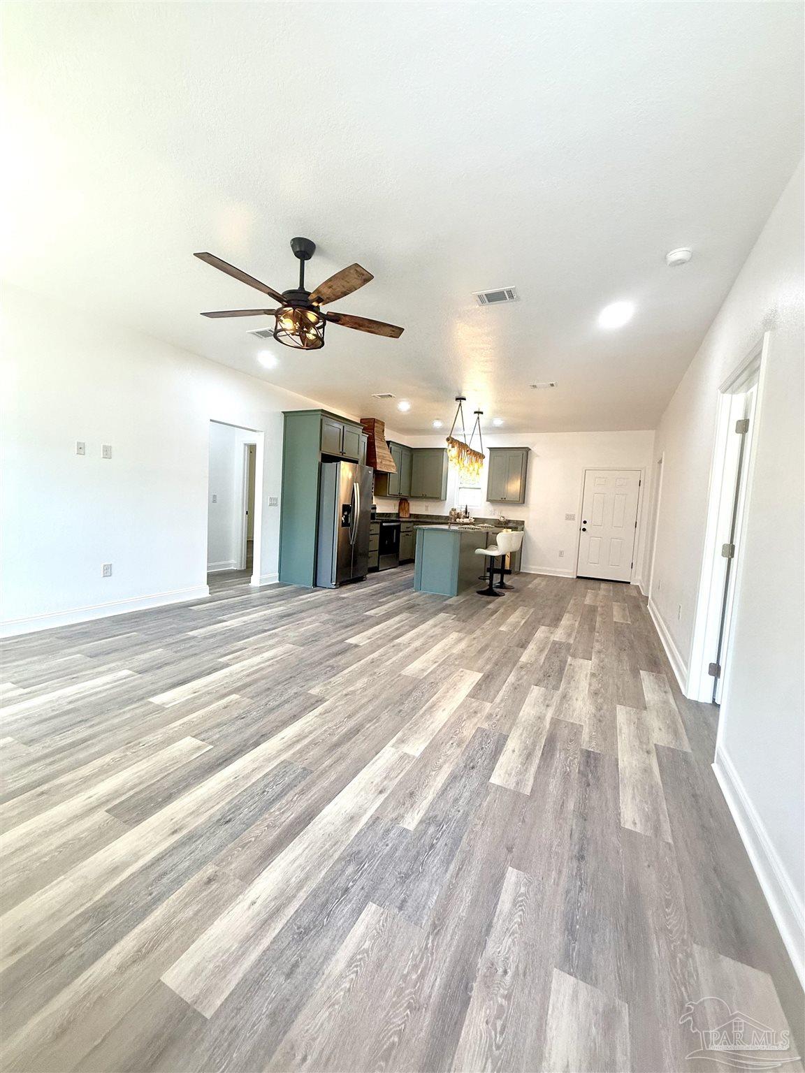 4035 Charles Circle Pace, FL 32571 - Photo 7 of 68 a view of livingroom with hardwood floor and a ceiling fan