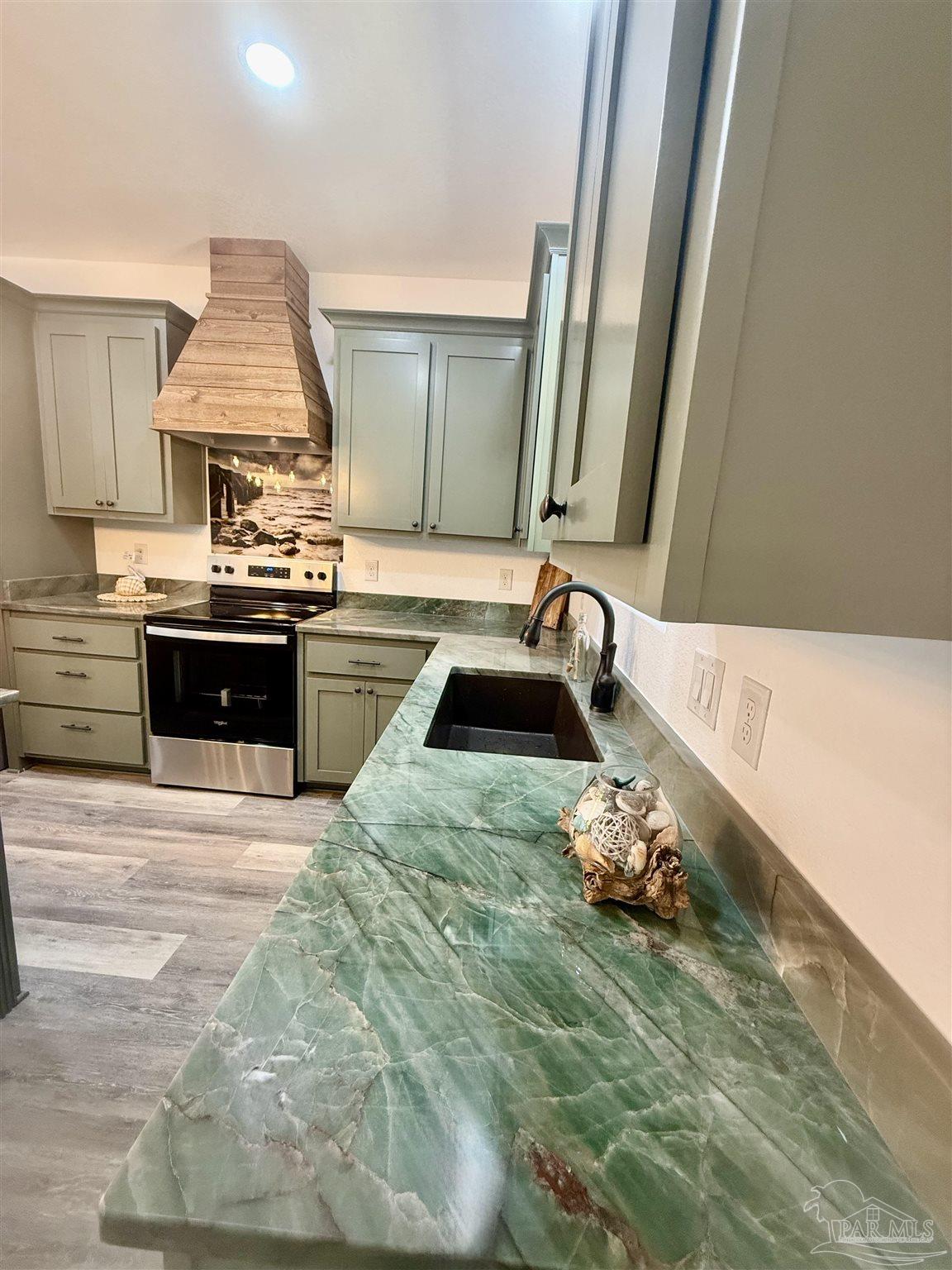 4035 Charles Circle Pace, FL 32571 - Photo 10 of 68 a kitchen with a sink and a stove top oven