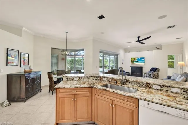 a view of a kitchen with kitchen island granite countertop a sink and a stove top oven