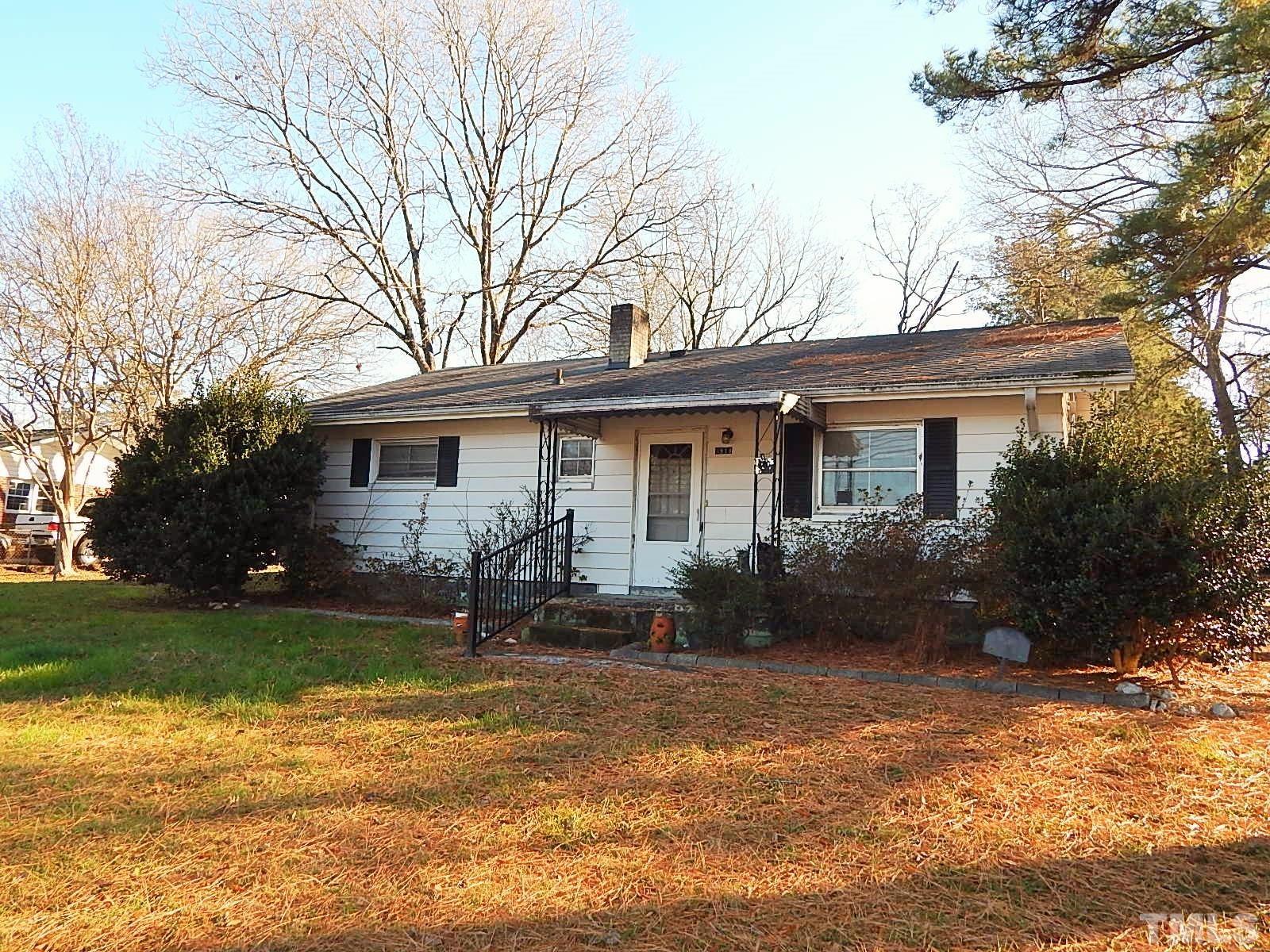 a front view of house with a garden