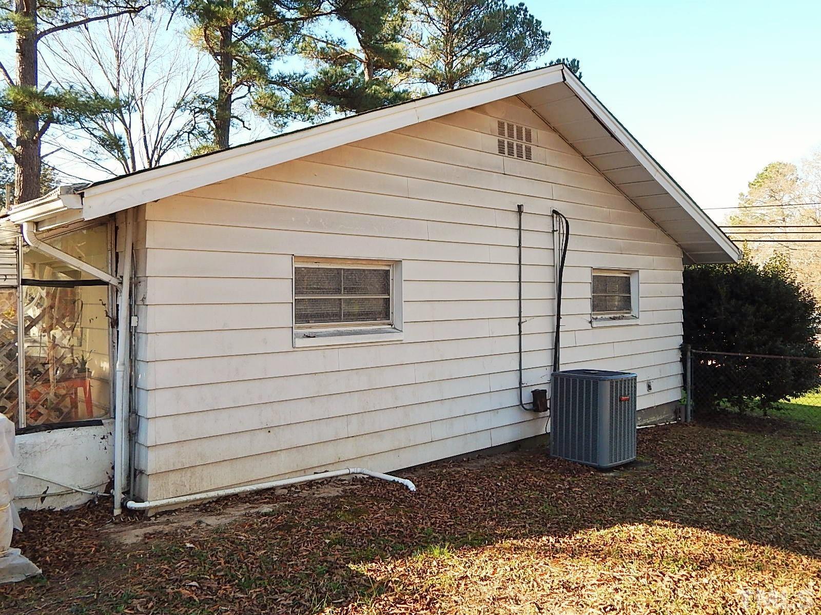 3914 Cheek Road Durham, NC 27704 - Photo 2 of 15 a view of a small white house with a white fence