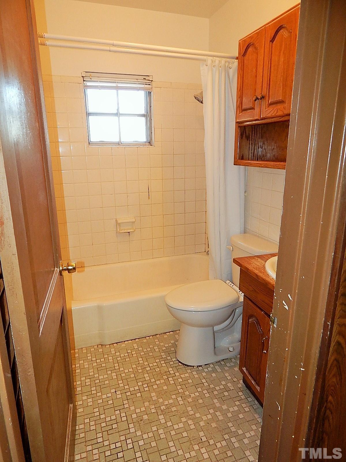 3914 Cheek Road Durham, NC 27704 - Photo 12 of 15 a bathroom with a toilet and a shower