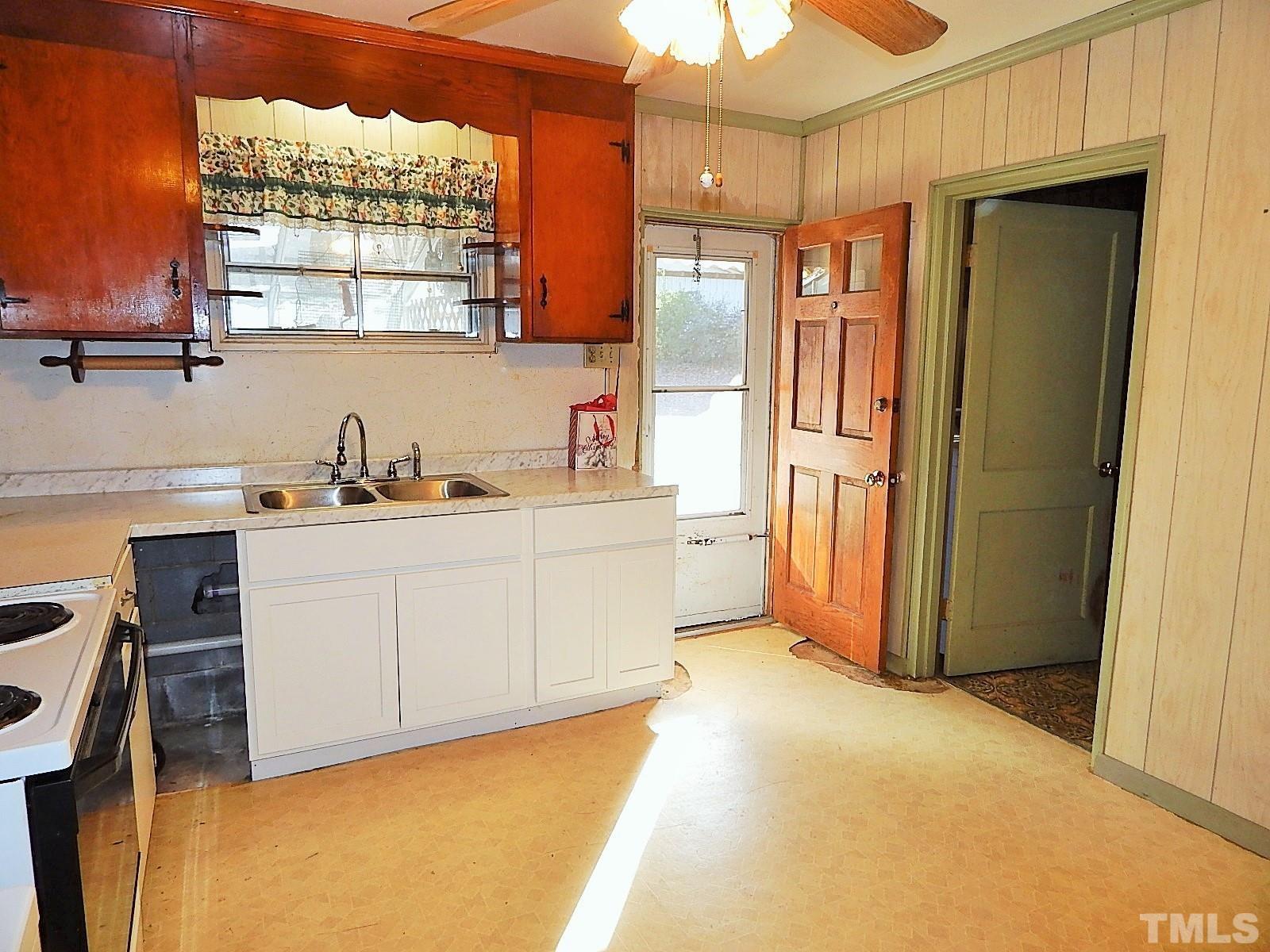 3914 Cheek Road Durham, NC 27704 - Photo 6 of 15 a kitchen with a refrigerator and window