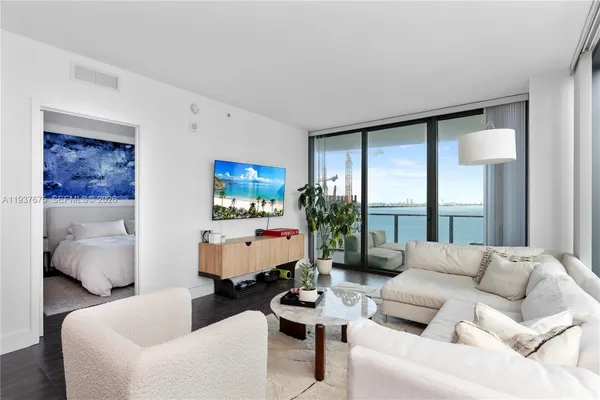 a living room with furniture and a large window