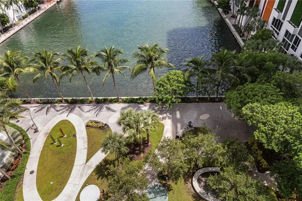 a view of a swimming pool with a yard and plants