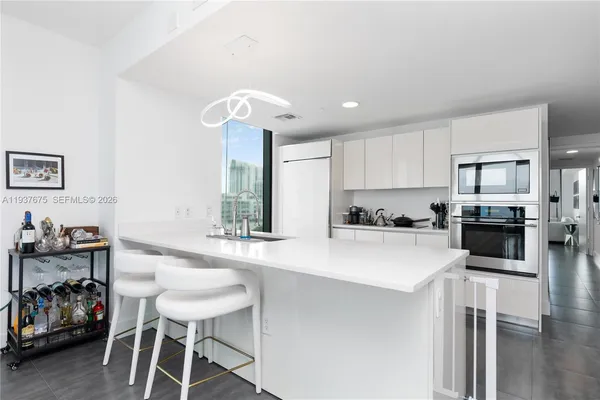 a kitchen with a sink cabinets and wooden floor