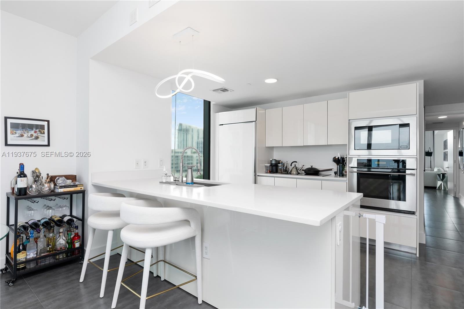 460 Northeast 28th Street, Unit 808 Miami, FL 33137 - Photo 15 of 41 a kitchen with a sink cabinets and wooden floor