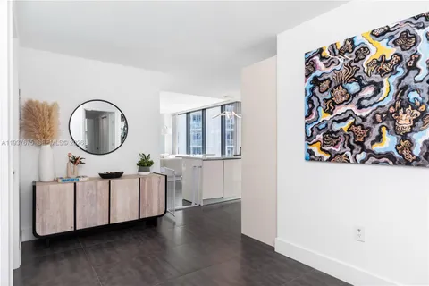 a large kitchen with stainless steel appliances a sink and a stove