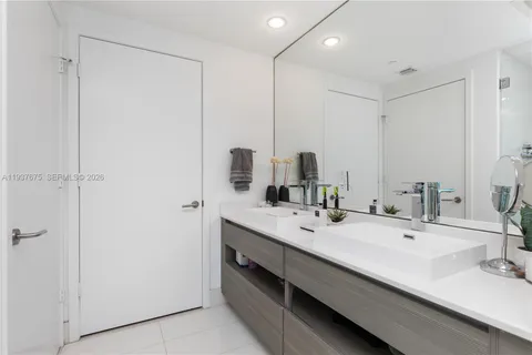 a bedroom with a large window and a balcony