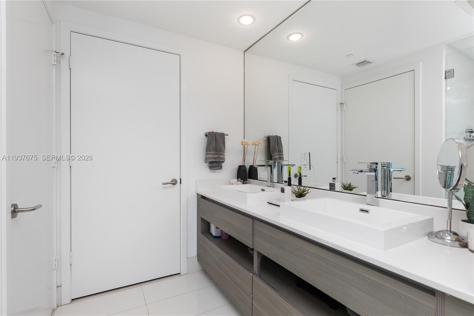 460 Northeast 28th Street, Unit 808 Miami, FL 33137 - Photo 26 of 41 a bathroom with double vanity and a mirror