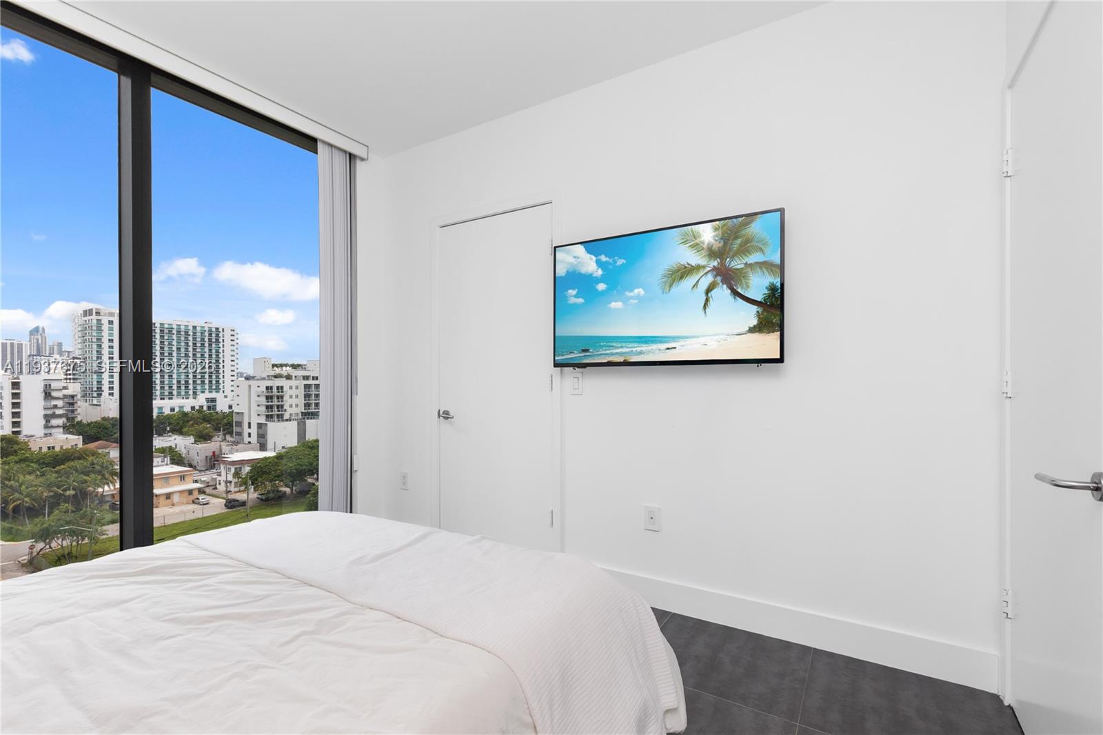 460 Northeast 28th Street, Unit 808 Miami, FL 33137 - Photo 27 of 41 a bedroom with a large window and a balcony