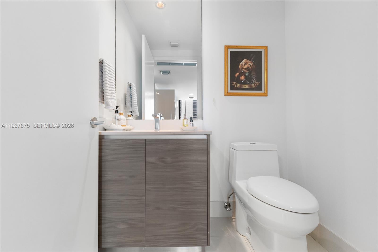 460 Northeast 28th Street, Unit 808 Miami, FL 33137 - Photo 29 of 41 a bathroom with a toilet sink vanity and mirror
